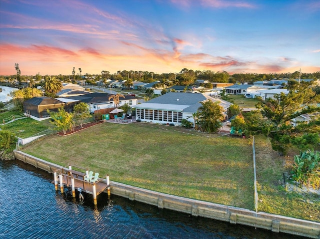 aerial view at dusk with a water view