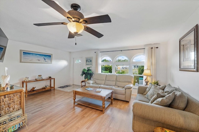 living room with light wood-type flooring and ceiling fan