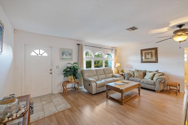 living room featuring ceiling fan and light hardwood / wood-style floors