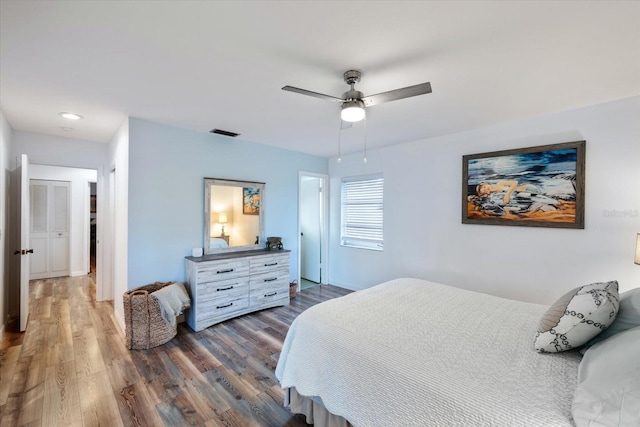 bedroom with ceiling fan and dark hardwood / wood-style flooring