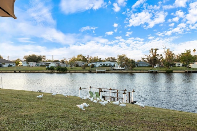 dock area featuring a yard and a water view