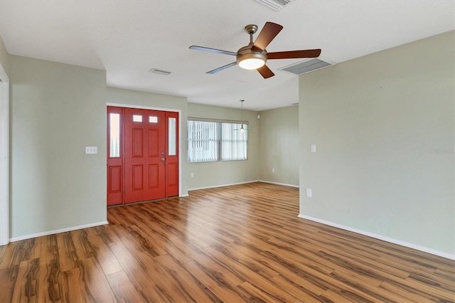 foyer entrance with ceiling fan and wood-type flooring