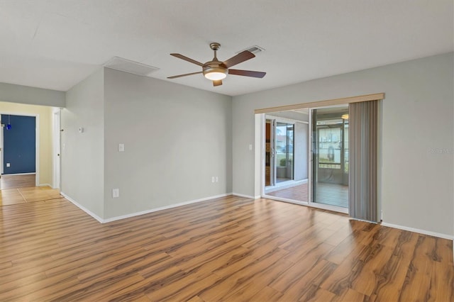 empty room with ceiling fan and light hardwood / wood-style floors