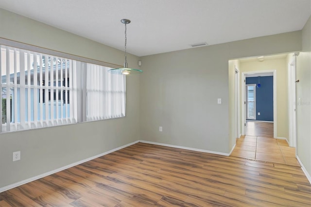 spare room with hardwood / wood-style floors