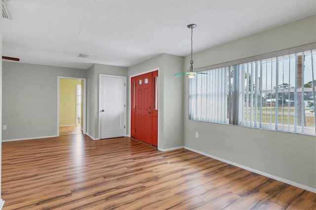 unfurnished room with hardwood / wood-style floors