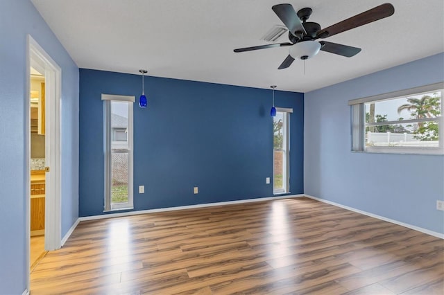 empty room with ceiling fan and wood-type flooring