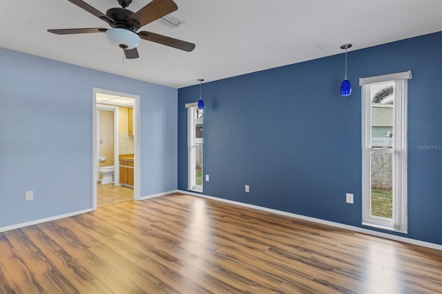 unfurnished room featuring ceiling fan and hardwood / wood-style floors