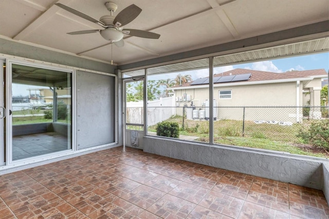 unfurnished sunroom with ceiling fan and coffered ceiling