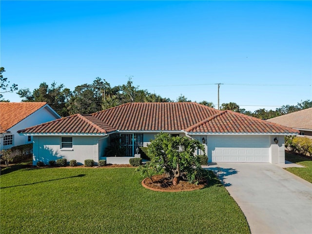 mediterranean / spanish home with a tile roof, stucco siding, concrete driveway, a front yard, and a garage