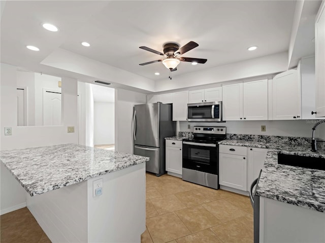 kitchen featuring light stone counters, recessed lighting, a sink, a ceiling fan, and appliances with stainless steel finishes