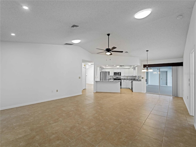 unfurnished living room featuring ceiling fan with notable chandelier, a textured ceiling, lofted ceiling, and visible vents