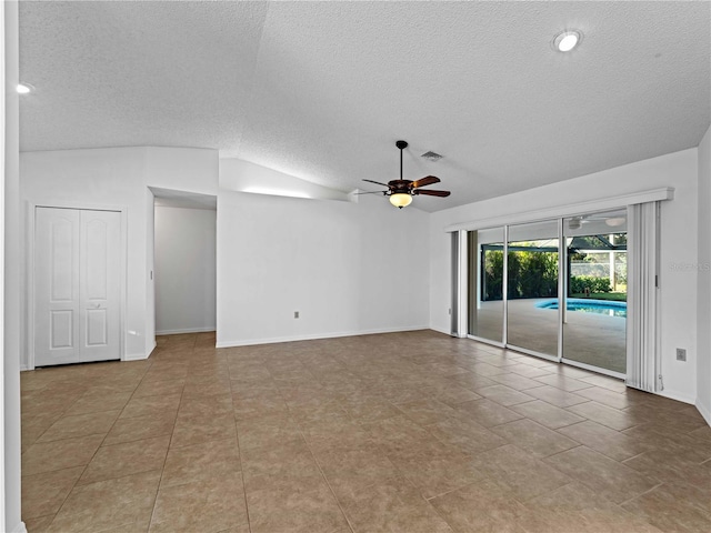 unfurnished room with visible vents, baseboards, a ceiling fan, lofted ceiling, and a textured ceiling