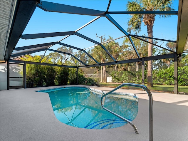 outdoor pool with a lanai and a patio