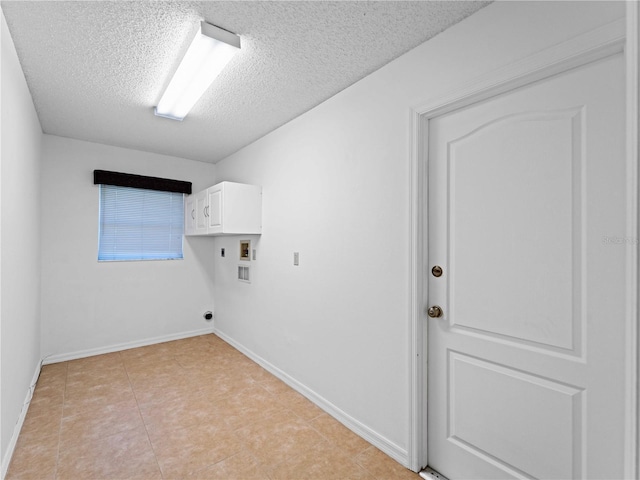 clothes washing area featuring cabinet space, baseboards, a textured ceiling, hookup for an electric dryer, and washer hookup