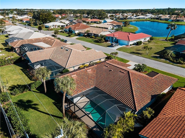 drone / aerial view with a water view and a residential view