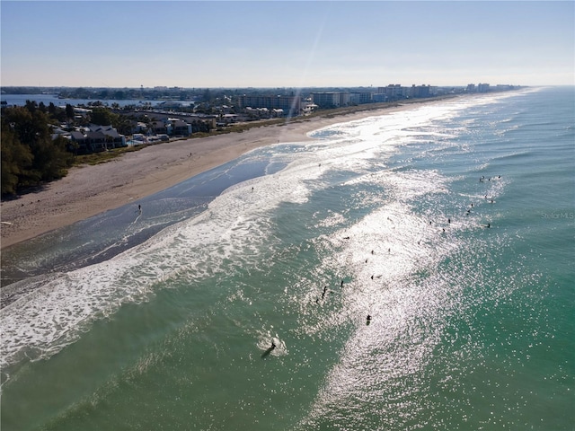 birds eye view of property with a water view and a view of the beach