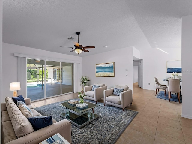 1678 Quail Lake Dr, Venice, FL 34293 - tiled living room with a textured ceiling, lofted ceiling, and a ceiling fan
