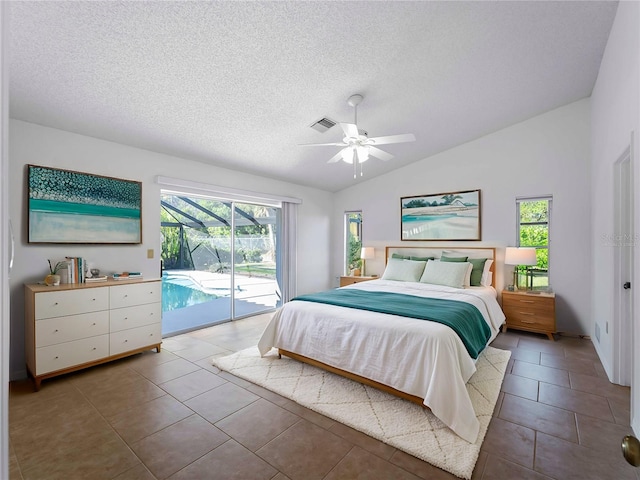 1678 Quail Lake Dr, Venice, FL 34293 - bedroom featuring access to outside, vaulted ceiling, multiple windows, a textured ceiling, and tile patterned flooring