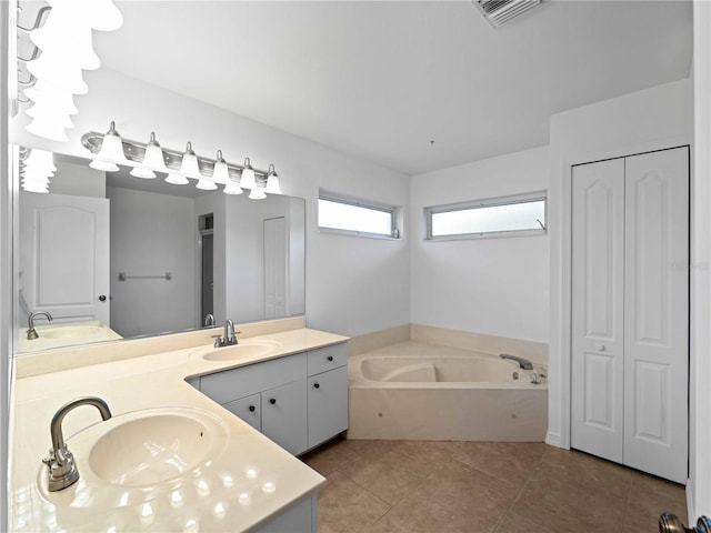 1678 Quail Lake Dr, Venice, FL 34293 - bathroom with a closet, double vanity, a garden tub, and tile patterned floors