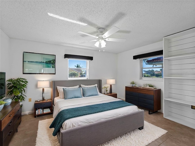 1678 Quail Lake Dr, Venice, FL 34293 - tiled bedroom with ceiling fan and a textured ceiling