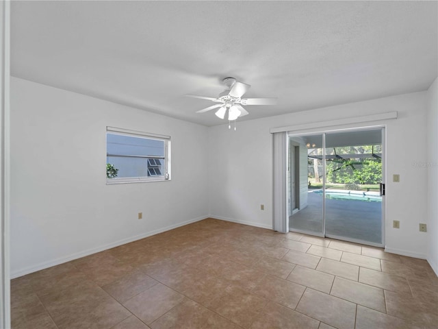 1678 Quail Lake Dr, Venice, FL 34293 - tiled spare room featuring a ceiling fan and baseboards