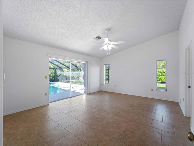 1678 Quail Lake Dr, Venice, FL 34293 - spare room with ceiling fan, a textured ceiling, vaulted ceiling, and baseboards