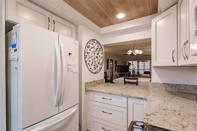 kitchen with a notable chandelier, crown molding, white fridge, white cabinets, and wood ceiling