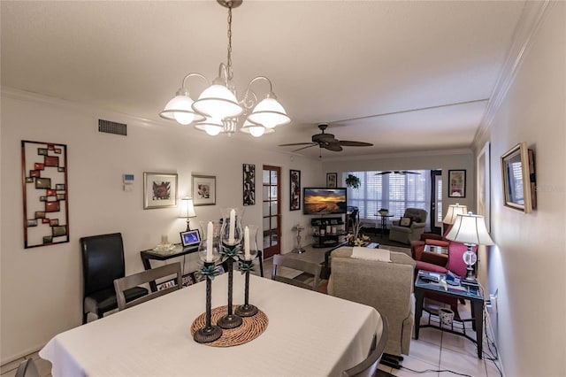 tiled dining space with crown molding and ceiling fan with notable chandelier