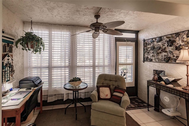 living area featuring ceiling fan and light tile patterned flooring