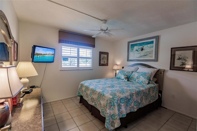 tiled bedroom featuring a textured ceiling and ceiling fan