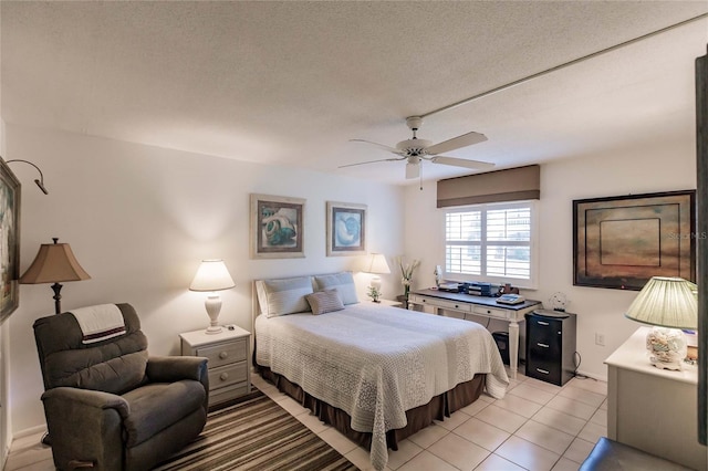 tiled bedroom featuring ceiling fan and a textured ceiling