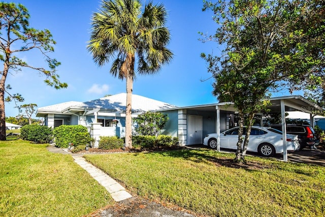 ranch-style home with a front yard and a carport