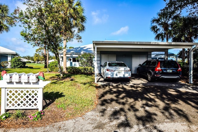 view of home's exterior with a lawn and a carport