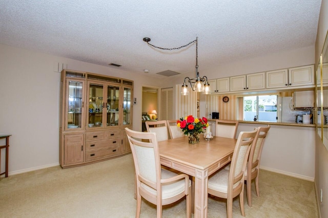 carpeted dining space featuring a textured ceiling and a notable chandelier