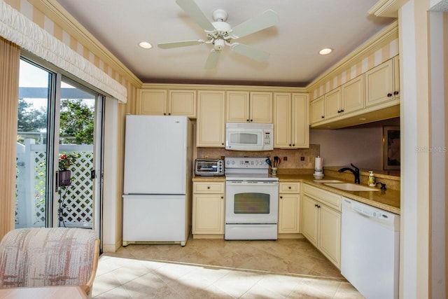 kitchen with ceiling fan, sink, cream cabinets, white appliances, and ornamental molding