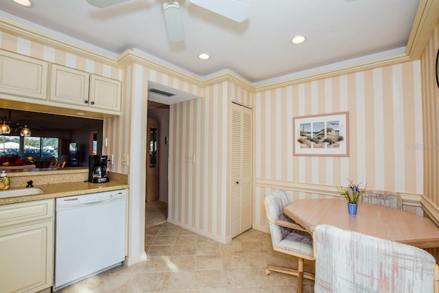 kitchen with white dishwasher, ceiling fan, crown molding, sink, and cream cabinets