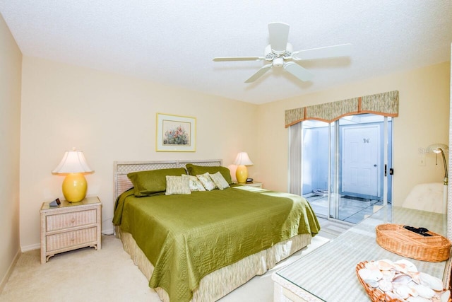 carpeted bedroom featuring access to outside, ceiling fan, and a textured ceiling