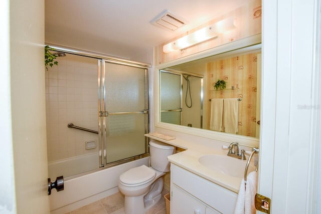 full bathroom with toilet, tile patterned flooring, vanity, and combined bath / shower with glass door