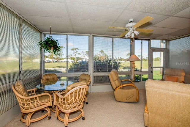 sunroom featuring a wealth of natural light, ceiling fan, and a drop ceiling