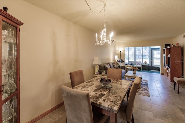 dining area featuring a chandelier and tile patterned floors