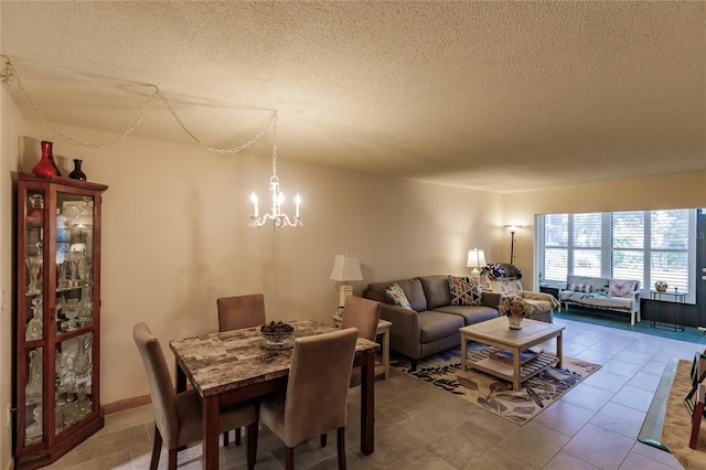 tiled dining area featuring a notable chandelier and a textured ceiling