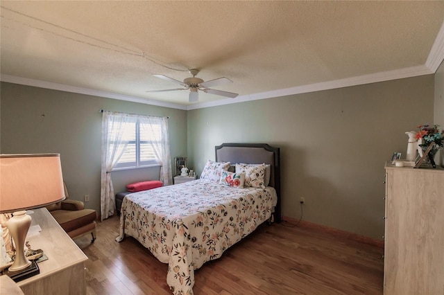 bedroom with ceiling fan, dark hardwood / wood-style flooring, ornamental molding, and a textured ceiling