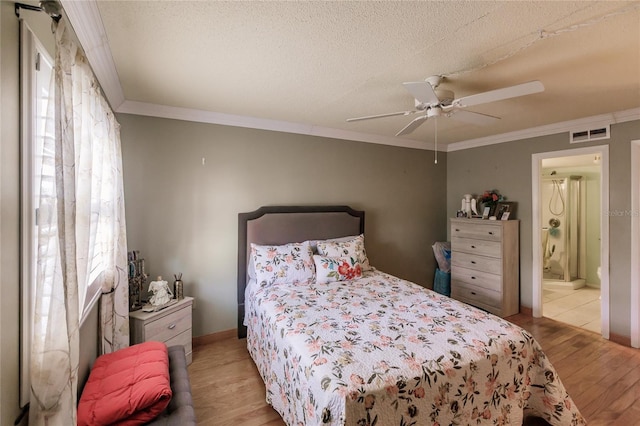 bedroom with crown molding, light hardwood / wood-style flooring, ceiling fan, a textured ceiling, and connected bathroom