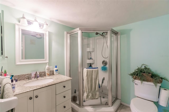 bathroom featuring vanity, toilet, and a shower with shower door