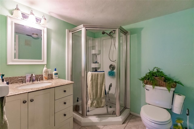 bathroom with tile patterned flooring, vanity, toilet, and a shower with shower door