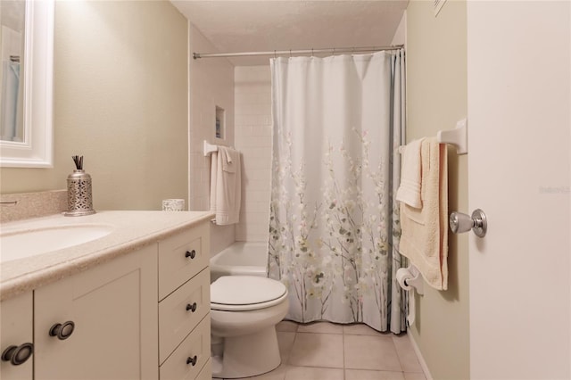 full bathroom featuring tile patterned flooring, vanity, toilet, and shower / bath combo with shower curtain