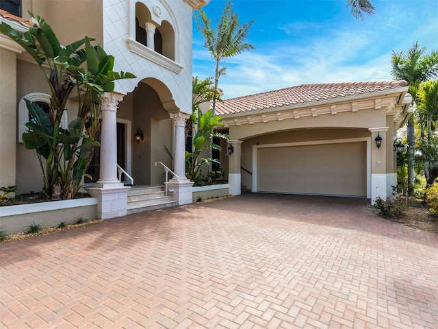 mediterranean / spanish home featuring a garage