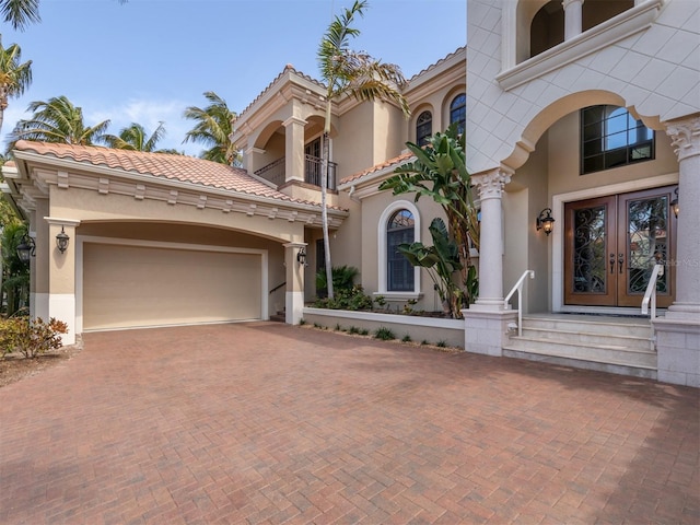 mediterranean / spanish home featuring french doors and a balcony