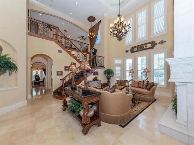 living room with crown molding, a high ceiling, and an inviting chandelier