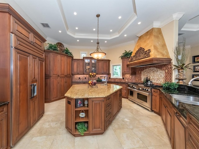 kitchen featuring custom exhaust hood, sink, decorative light fixtures, a center island with sink, and high quality appliances